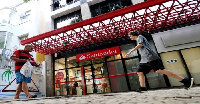 FILE PHOTO: People walk past a Banco Santander branch in Rio de Janeiro
