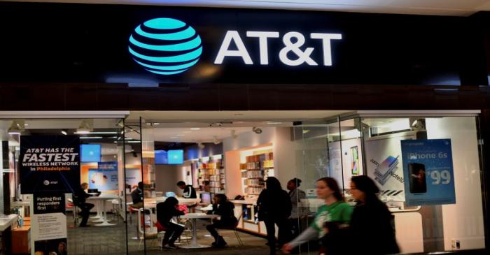 FILE PHOTO: Shoppers walk past an AT&T as holiday shopping accelerates at the King of Prussia