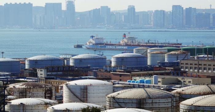 FILE PHOTO: China Ocean Shipping Company (COSCO) vessel is seen near oil tanks at the China