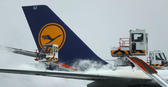 A Lufthansa passenger aircraft undergoes de-icing before takeoff from Frankfurt airport