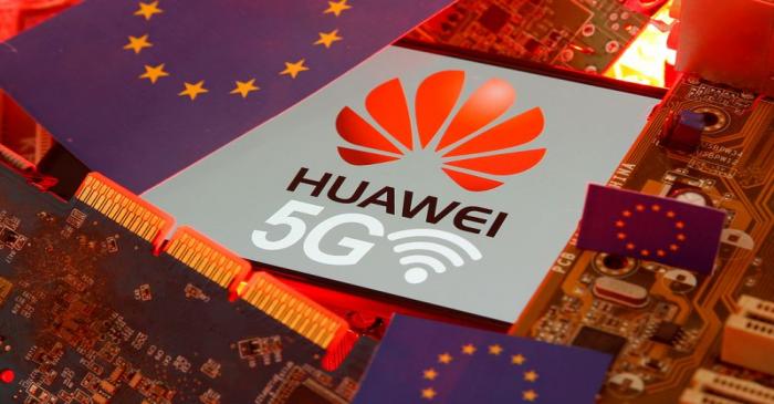 FILE PHOTO: The EU flag and a smartphone with the Huawei and 5G network logo are seen on a PC