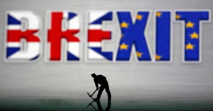 A small toy figure is seen in front of a Brexit logo in this illustration picture