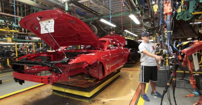 The frame of a 2015 Ford Mustang vehicle moves down the production line at the Ford Motor Flat