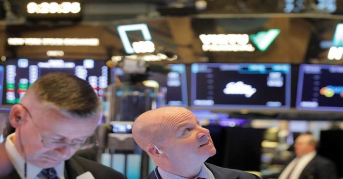 Traders work on the floor of the New York Stock Exchange shortly after the opening bell in New