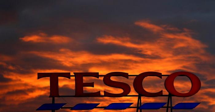 A company logo is pictured outside a Tesco  supermarket in Altrincham northern England.