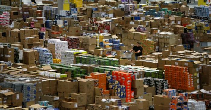 A worker sorts packages at the Amazon warehouse in Leipzig