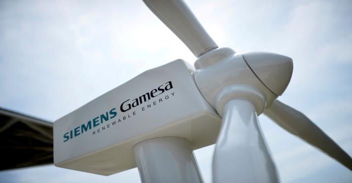 FILE PHOTO: A model of a wind turbine with the Siemens Gamesa logo is displayed outside the