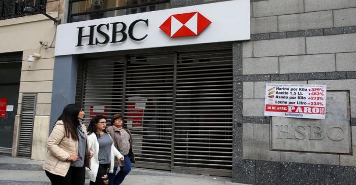 Pedestrians walk past closed HSBC bank during a national strike in Buenos Aires