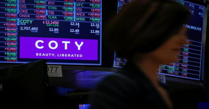 A screen displays the logo and trading information for Coty Inc at the NYSE in New York