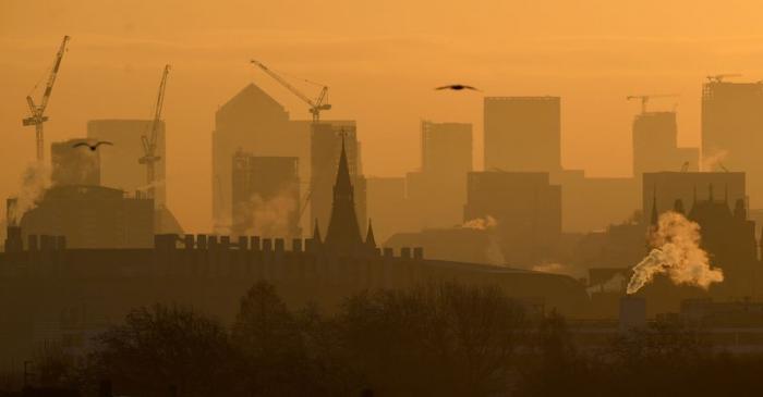 Skyscrapers and buildings are seen at dawn looking across central London towards the Canary