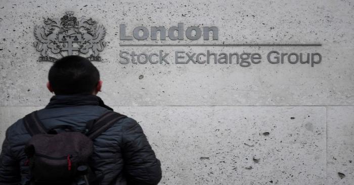 FILE PHOTO:  People walk past the London Stock Exchange Group offices in the City of London,