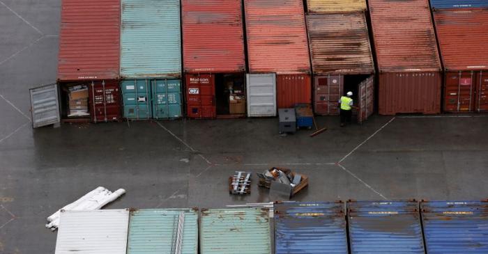 A worker opens the door of a container at DP World London Gateway container port in Essex,