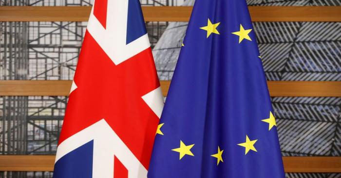 A Union Jack flag and a European Union flag are seen ahead of a bilateral meeting between