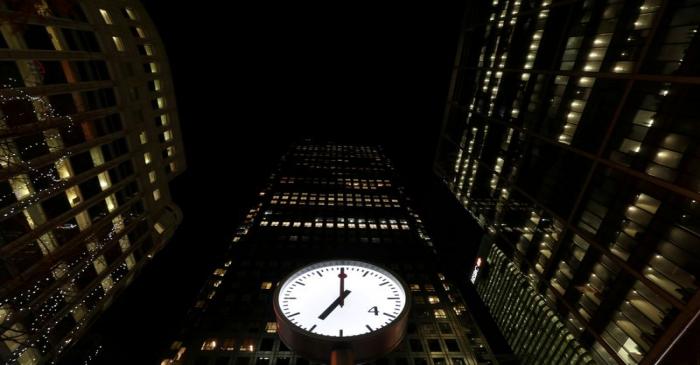 FILE PHOTO: Clocks in London's Canary Wharf financial centre strike 07:00 GMT, marking the time