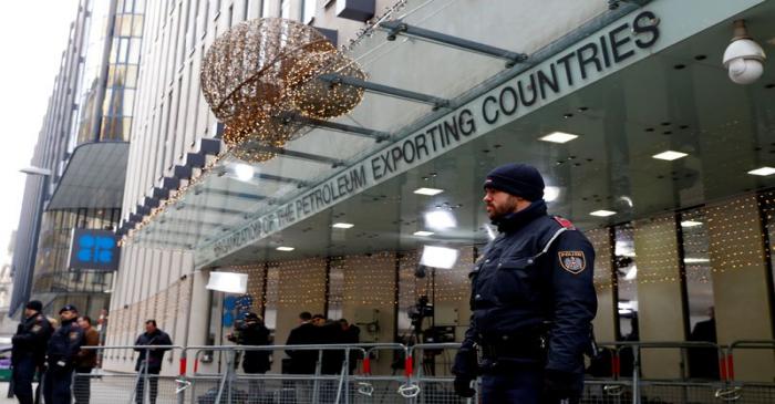 FILE PHOTO: Journalists and police officers stand outside the Organisation of the Petroleum