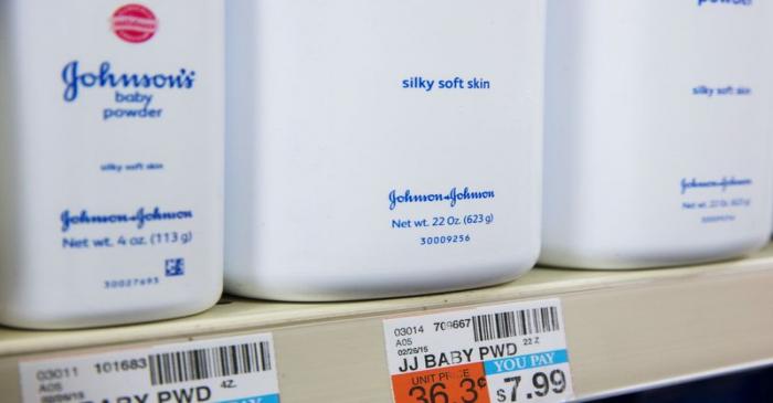 Bottles of Johnson & Johnson baby powder line a drugstore shelf in New York