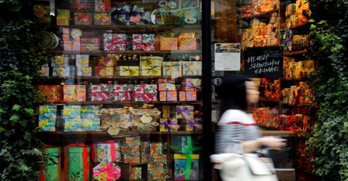 Woman walks outside a shop in a shopping district in Tokyo