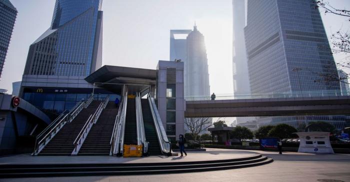 FILE PHOTO: People wearing masks are seen at Lujiazui financial district in Pudong, Shanghai