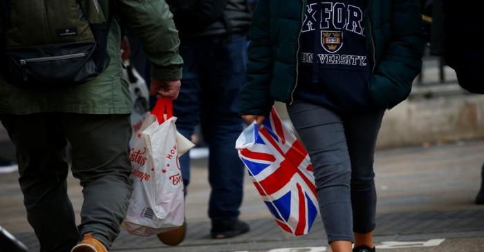 Shoppers carry shopping in plastic bags in the West End, in London