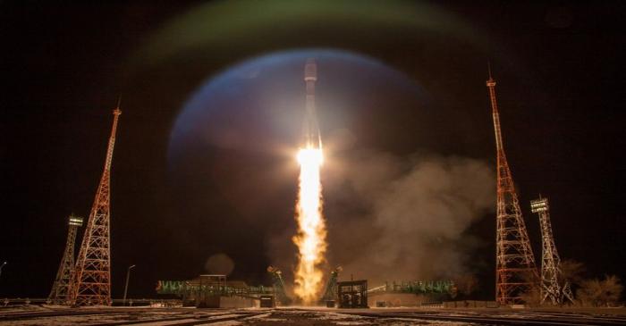 A rocket carrying OneWeb satellites blasts off from a launchpad at the Baikonur Cosmodrome