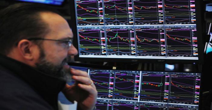 A trader works on the floor of the New York Stock Exchange shortly after the opening bell in