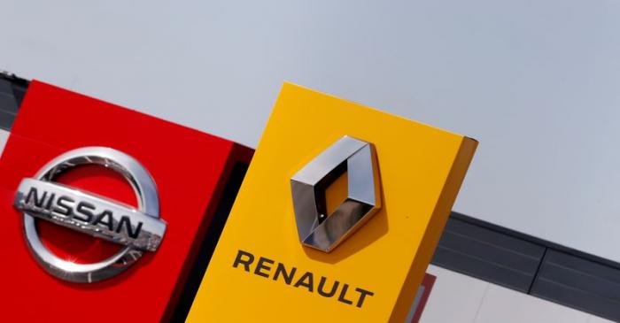 FILE PHOTO: The logos of car manufacturers Renault and Nissan are seen in front of dealerships