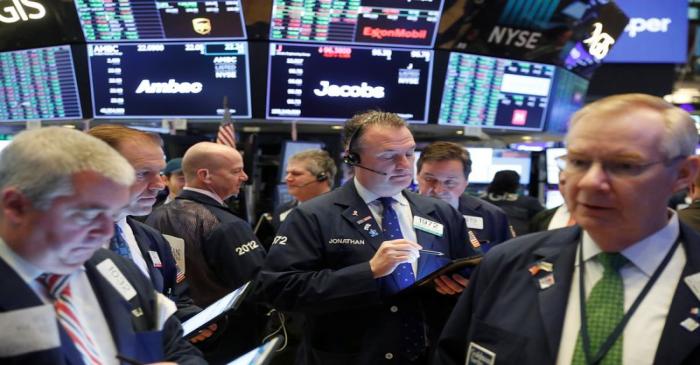 Traders work on the floor of the New York Stock Exchange shortly after the opening bell in New