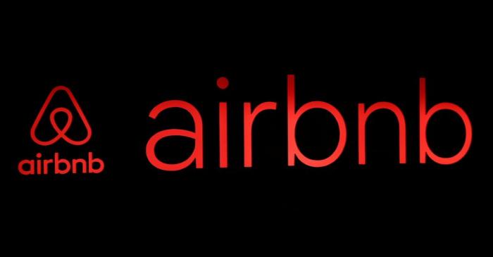 The logos of Airbnb are displayed at an Airbnb event in Tokyo