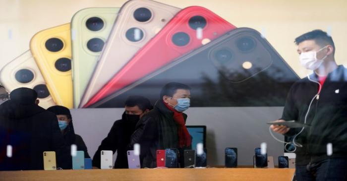FILE PHOTO:  People wearing protective masks are seen in an Apple Store, as China is hit by an