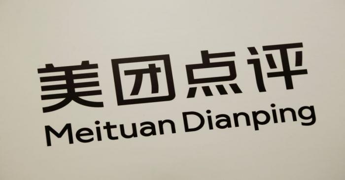 Company logo of China's Meituan Dianping is displayed at a news conference in Hong Kong