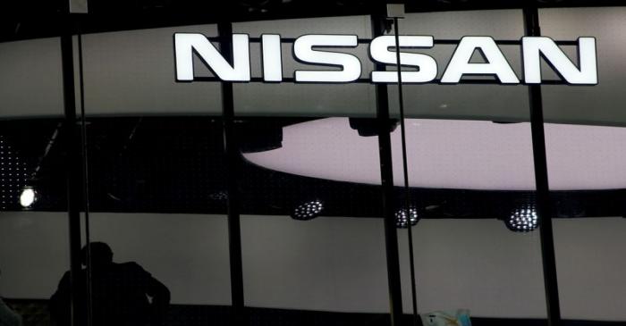 FILE PHOTO: Man is silhouetted at a show room of Nissan Motor Co. in Tokyo