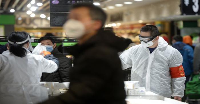 Customers wearing face masks shop inside a supermarket following an outbreak of the novel