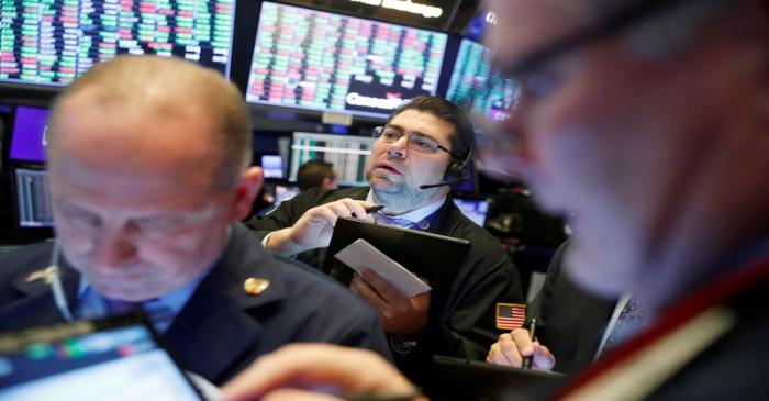 Traders work on the floor of the New York Stock Exchange shortly after the opening bell in New