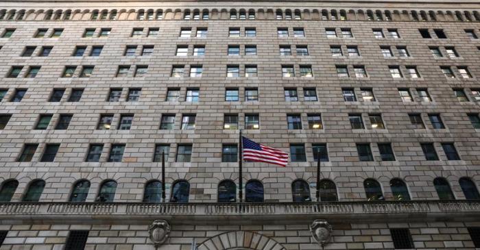 The U.S. flag flies on the Federal Reserve Bank of New York in the financial district in New