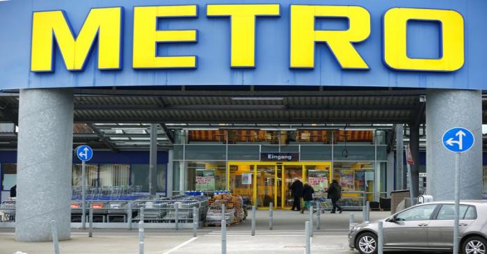 FILE PHOTO: People enter German retailer Metro AG supermarket in Duesseldorf