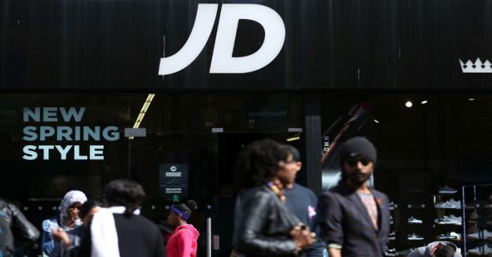 FILE PHOTO: People pass a JD Sports store in London