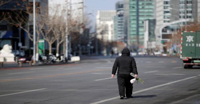 FILE PHOTO: Man walks along the Financial Street in central Beijing