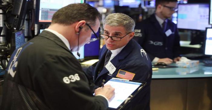 Traders work on the floor of the New York Stock Exchange shortly after the opening bell in New