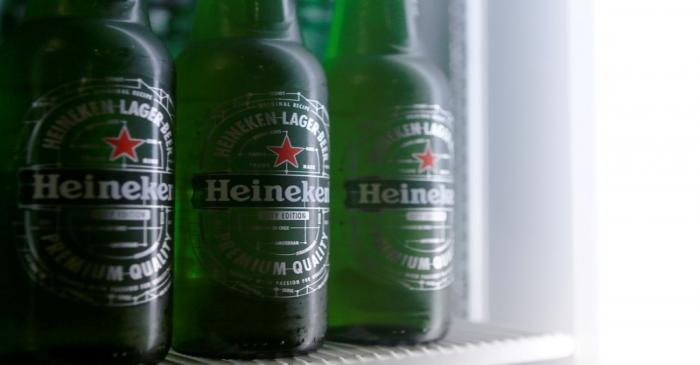 Botttles of Heineken lager beer are seen in a picture illustration inside a refrigerator in