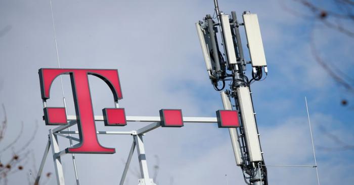 Logo of German telecommunications giant Deutsche Telekom AG and GSM antennas are seen atop of