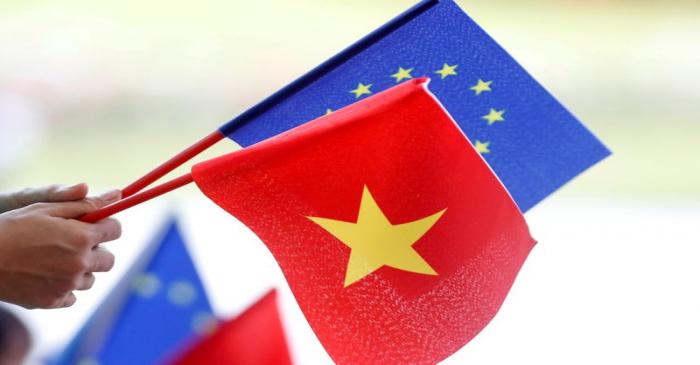 FILE PHOTO: European Union and Vietnamese flags are seen at the signing ceremony of EU-Vietnam