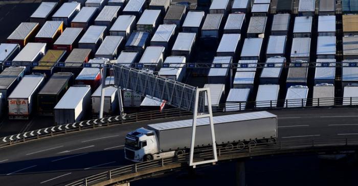 A lorry is driven past dozens of others parked after traveling by ferry between Britain and