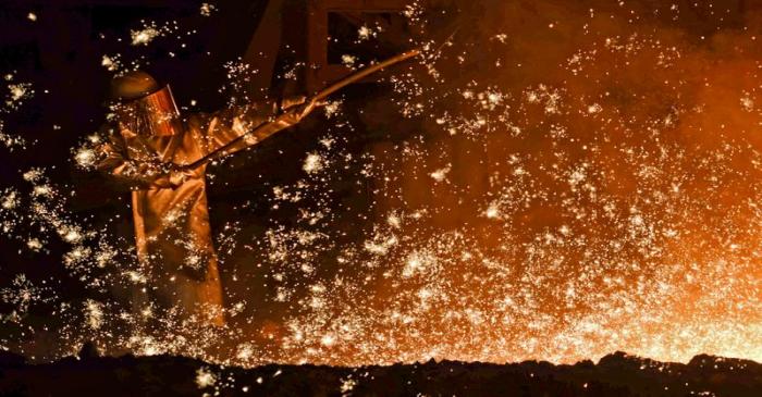 A steel-worker is pictured at a furnace at the plant of German steel company Salzgitter AG in