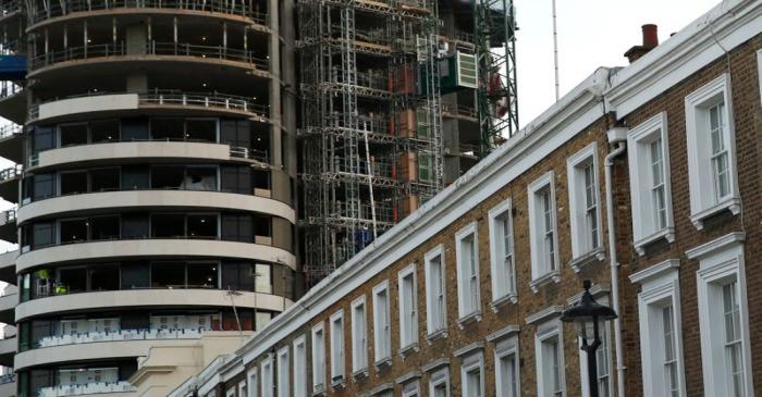 An apartment block is constructed behind a row of traditional properties in central London