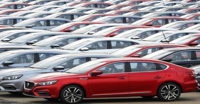 FILE PHOTO:  Cars for export wait to be loaded onto cargo vessels at a port in Lianyungang