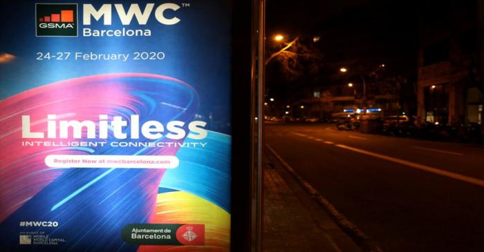 Banner of MWC20 is pictured at a bus stop along a street in Barcelona