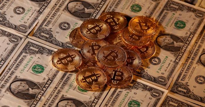 FILE PHOTO: Representations of virtual currency Bitcoin and U.S. dollar banknotes are seen in
