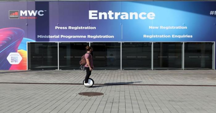 Man rides at Fira de Barcelona after the Mobile World Congress (MWC) was cancelled, in