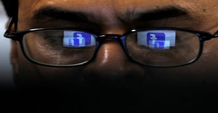 Facebook logo is reflected in glasses in this picture illustration
