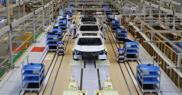 Workers are seen on the production line at Honda Motor's new joint venture plant with Dongfeng